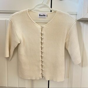 White elbow-sleeve top with pearl buttons